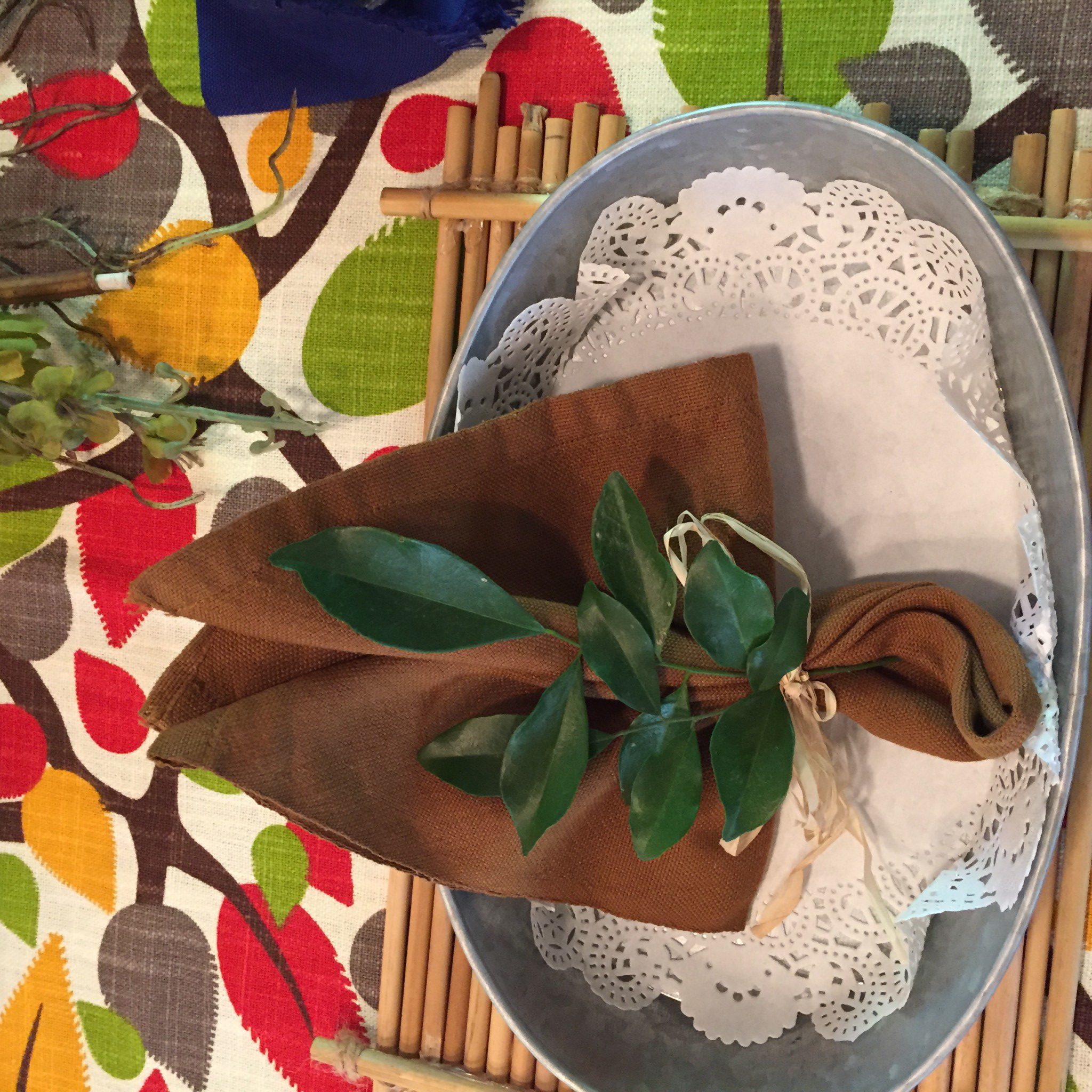 Rosal leaves as napkin rings.  Tin plates glammed up with white doilies. 